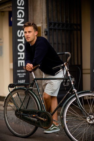 Navy Long Sleeve T-Shirt Outfits For Men: For an off-duty look, consider teaming a navy long sleeve t-shirt with white and black vertical striped shorts — these items fit really well together. The whole ensemble comes together when you complete your getup with olive canvas low top sneakers.