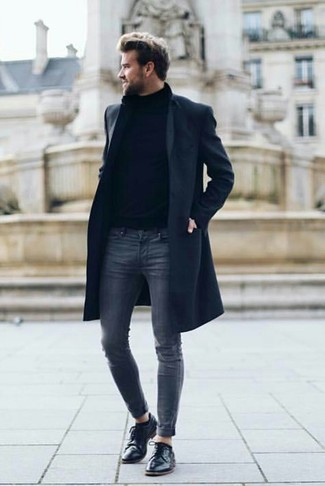 Navy Skinny Jeans Outfits For Men: If you feel more confident wearing something practical, you'll appreciate this laid-back combo of a navy overcoat and navy skinny jeans. Tap into some David Beckham dapperness and add a pair of black leather derby shoes to your look.