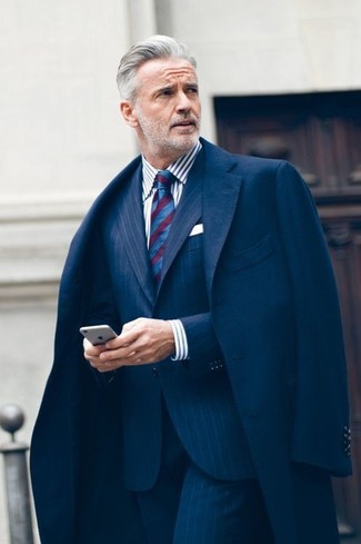 For an ensemble that's classy and Kingsman-worthy, marry a navy overcoat with a navy vertical striped suit.