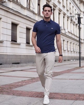 Beige Chinos Hot Weather Outfits: A navy polo and beige chinos are an easy way to inject extra cool into your daily off-duty wardrobe. A pair of white canvas low top sneakers complements this ensemble very nicely.