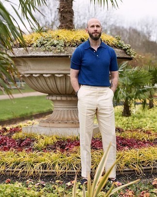 Navy Canvas Loafers Outfits For Men: Marry a navy polo with beige dress pants to achieve an interesting and pulled together ensemble. You could perhaps get a bit experimental when it comes to shoes and complete this look with navy canvas loafers.