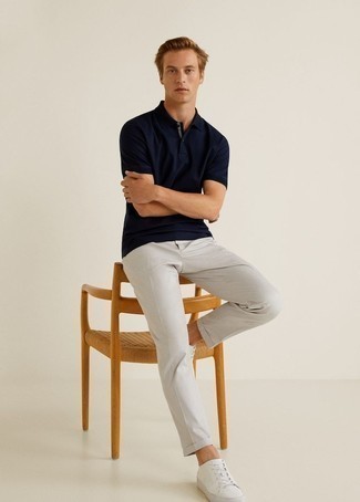Grey Chinos Outfits: You'll be surprised at how easy it is for any guy to get dressed this way. Just a navy polo and grey chinos. A pair of white canvas low top sneakers looks perfectly at home here.