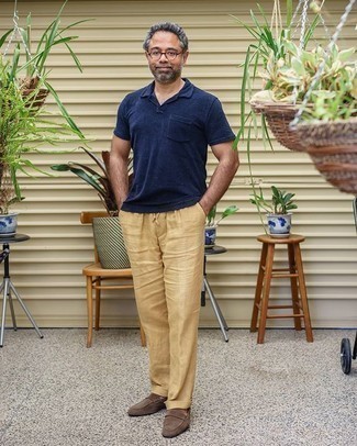 Khaki Linen Chinos Outfits: This combination of a navy polo and khaki linen chinos is hard proof that a safe casual look doesn't have to be boring. Take this getup down a more sophisticated path by slipping into a pair of brown suede loafers.