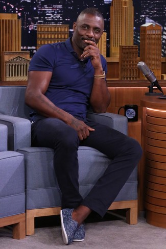 Idris Elba wearing Navy Polo, Navy Chinos, Navy Canvas Slip-on Sneakers, Gold Watch