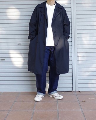 Blue Raincoat Outfits For Men: A blue raincoat and navy jeans will bring extra style to your day-to-day off-duty lineup. Consider white canvas low top sneakers as the glue that brings this ensemble together.