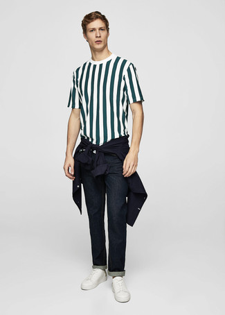 Dark Green Vertical Striped Crew-neck T-shirt Outfits For Men: Choose a dark green vertical striped crew-neck t-shirt and navy jeans if you wish to look casually dapper without much effort. White leather low top sneakers work amazingly well with this outfit.