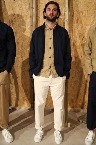 Navy Shirt Jacket Outfits For Men: Such essentials as a navy shirt jacket and white chinos are the ideal way to infuse some rugged sophistication into your casual styling collection. Go the extra mile and jazz up your ensemble by finishing off with a pair of white canvas low top sneakers.