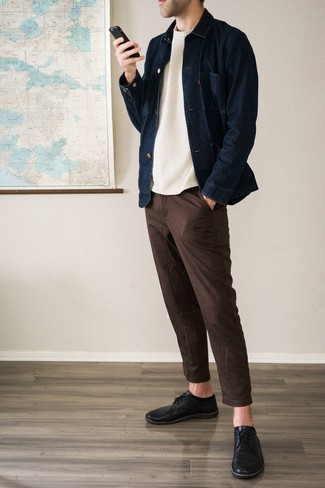 Dark Brown Chinos Outfits: This semi-casual pairing of a navy denim shirt jacket and dark brown chinos takes on different nuances according to the way it's styled. Balance your look with a sleeker kind of footwear, such as these black leather derby shoes.