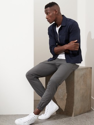 Grey Chinos Outfits: Boost your sartorial game in this combo of a navy shirt jacket and grey chinos. To infuse an element of stylish effortlessness into your ensemble, complete this ensemble with white canvas high top sneakers.