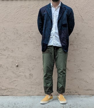 Beige Canvas Slip-on Sneakers Outfits For Men: This combination of a navy shirt jacket and dark green chinos can only be described as devastatingly dapper and casually sleek. Feeling inventive today? Mix things up a bit by rounding off with beige canvas slip-on sneakers.