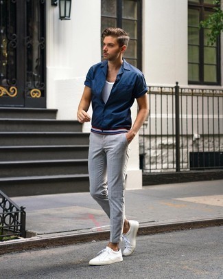 Charcoal Check Chinos Outfits: For an on-trend getup without the need to sacrifice on practicality, we turn to this pairing of a navy short sleeve shirt and charcoal check chinos. White leather low top sneakers make this look whole.