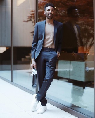 Navy Suit Outfits: Such items as a navy suit and a beige long sleeve t-shirt are the ideal way to introduce some refinement into your casual styling rotation. A pair of white canvas low top sneakers will add an easy-going vibe to this outfit.