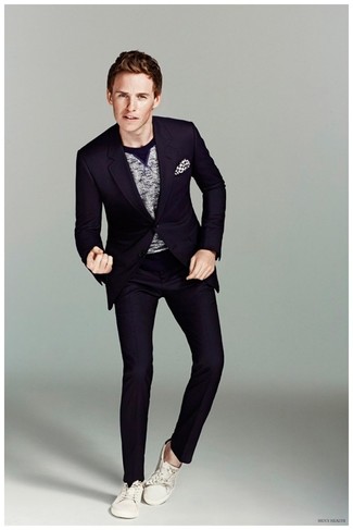 Eddie Redmayne wearing Navy Suit, Grey Crew-neck Sweater, White Canvas Low Top Sneakers, White and Black Polka Dot Pocket Square