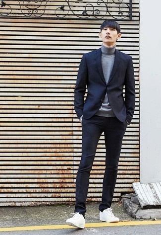 Grey Turtleneck with White Canvas Low Top Sneakers Smart Casual Outfits For Men: You'll be surprised at how extremely easy it is to pull together this sophisticated outfit. Just a grey turtleneck and a navy suit. White canvas low top sneakers are an effortless way to inject a dose of stylish effortlessness into this outfit.