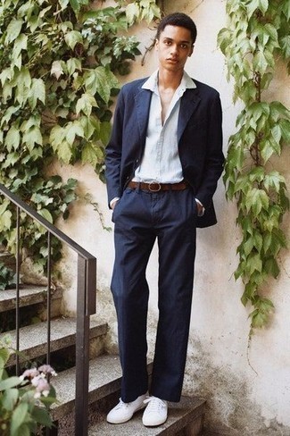 Navy Suit Outfits: Marrying a navy suit and a light blue dress shirt is a guaranteed way to breathe masculine elegance into your styling collection. For something more on the daring side to complete this outfit, add a pair of white canvas low top sneakers to the equation.
