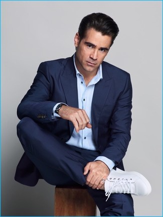This combo of a navy suit and a light blue long sleeve shirt is a goofproof option when you need to look truly sophisticated. To inject a more casual vibe into this ensemble, add a pair of white leather low top sneakers to the mix.