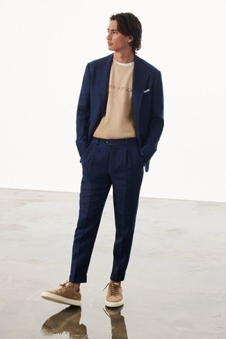 Navy Suit Outfits: As you can see here, it doesn't take that much work for a man to look effortlessly smart. Just rock a navy suit with a tan print crew-neck t-shirt and be sure you'll look amazing. Rev up the wow factor of this getup by wearing a pair of tan suede low top sneakers.