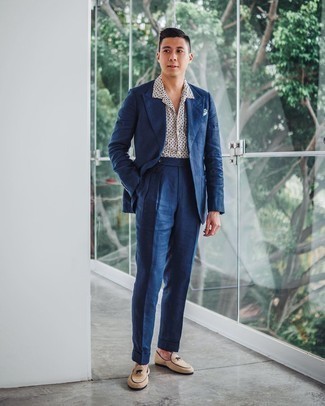 Navy Suit Outfits: A navy suit and a white and navy print short sleeve shirt are the kind of a no-brainer combo that you need when you have no time to spare. Beige suede loafers will infuse an added touch of style into an otherwise utilitarian getup.
