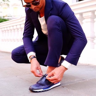 Navy Leather Low Top Sneakers Outfits For Men: A navy suit and a white crew-neck sweater are a seriously smart ensemble for you to try. To add a sense of stylish casualness to your outfit, complement this ensemble with navy leather low top sneakers.