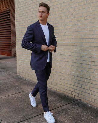 Navy Suit Outfits: For an effortlessly classic look, opt for a navy suit and a white crew-neck t-shirt — these items go perfectly well together. Finishing off with white leather low top sneakers is an easy way to add a laid-back vibe to your outfit.