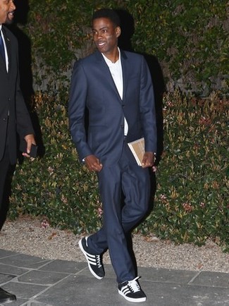Black and White Low Top Sneakers with Dress Shirt Dressy Summer Outfits For Men: A dress shirt and a navy suit are a classy combination that every sharp gent should have in his sartorial collection. And if you want to effortlessly dial down this look with one single piece, complete this getup with black and white low top sneakers. There are many ways to look neat and survive the heatwave, and that's one of them.