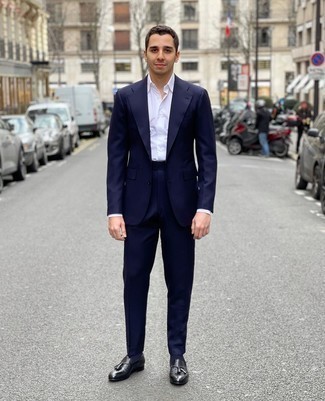 Black Leather Tassel Loafers Outfits: Pairing a navy suit and a white dress shirt is a guaranteed way to infuse your styling lineup with some manly sophistication. A pair of black leather tassel loafers can easily play down an all-too-polished look.