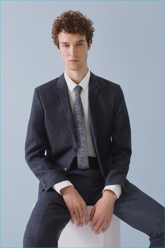 Grey Knit Tie Outfits For Men: This combination of a navy suit and a grey knit tie is ideal for dressier settings.