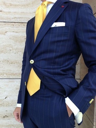 Mustard Tie Outfits For Men: Opt for a navy vertical striped suit and a mustard tie for seriously classic attire.