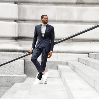 Navy Suit Outfits: This combo of a navy suit and a white turtleneck is extra dapper and creates instant appeal. If you need to immediately dial down your getup with shoes, introduce a pair of white canvas low top sneakers to the equation.