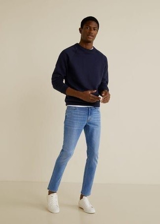 Blue Sweatshirt Outfits For Men: Hard proof that a blue sweatshirt and light blue skinny jeans look amazing when paired up in an off-duty getup. If you don't know how to finish off, a pair of white canvas low top sneakers is a winning option.