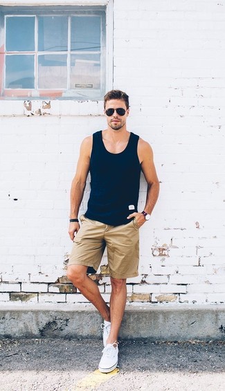 Navy Tank Outfits For Men: Wear a navy tank with tan shorts for a trendy and easy-going getup. Complement this ensemble with a pair of white canvas low top sneakers to take things up a notch.