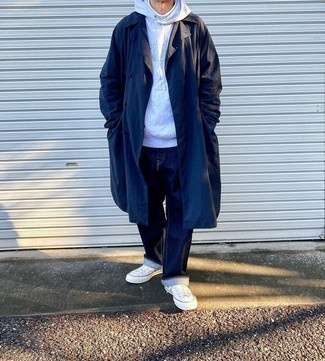 Coat Outfits For Men: Putting together a coat and navy jeans is a fail-safe way to breathe style into your styling arsenal. Let your sartorial skills really shine by finishing off this outfit with white canvas low top sneakers.