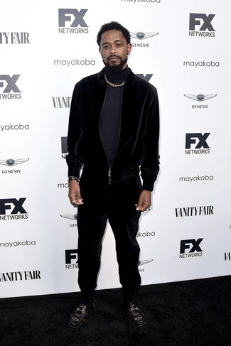 Lakeith Stanfield wearing Navy Turtleneck, Black Velvet Track Suit, Black Embroidered Leather Loafers, Black Leather Watch