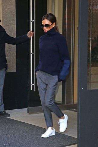 We're loving the way this pairing of a navy turtleneck and grey tapered pants immediately makes you look totaly chic. If you want to immediately dial down this ensemble with a pair of shoes, why not round off with a pair of white leather low top sneakers?