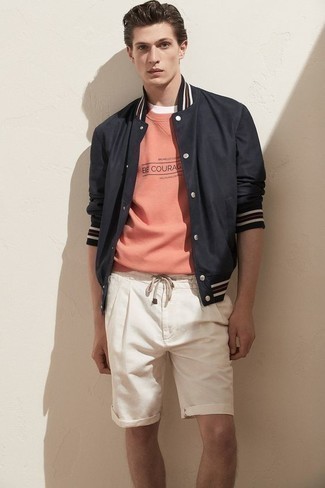 Pink Sweatshirt Outfits For Men: Pair a pink sweatshirt with white shorts for a standout getup.