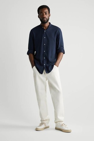 White Jeans Outfits For Men: Go for a navy vertical striped long sleeve shirt and white jeans to showcase you've got expert menswear prowess. Our favorite of a countless number of ways to finish off this outfit is a pair of white canvas low top sneakers.