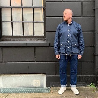 500+ Outfits For Men After 40: If you're searching for a relaxed but also stylish look, opt for a navy windbreaker and navy jeans. Tone down this look with white canvas high top sneakers. This ensemble illustrates that as a middle-aged gent, you have a wide range of outfit options.