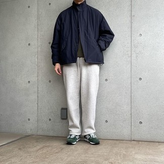 Men's Outfits 2021: Get into zen mode in this practical pairing of a navy windbreaker and grey sweatpants. If you want to instantly dress down this outfit with a pair of shoes, introduce a pair of dark green athletic shoes to the mix.