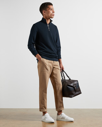 Dark Brown Leather Holdall Outfits For Men: Hard proof that a navy zip neck sweater and a dark brown leather holdall look amazing if you pair them together in a casual street style outfit. Clueless about how to finish off your outfit? Rock a pair of white leather low top sneakers to dress it up.