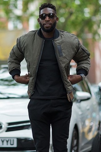 Dark Green Bomber Jacket Outfits For Men: Make a dark green bomber jacket and black sweatpants your outfit choice to don a casually dapper look.