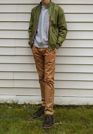 Olive Bomber Jacket Outfits For Men: If you're after a casual and at the same time on-trend ensemble, pair an olive bomber jacket with khaki chinos. Complement your ensemble with dark brown leather desert boots for extra style points.