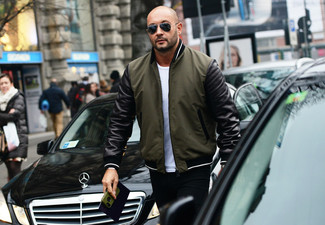 Dark Green Bomber Jacket Outfits For Men: One of the coolest ways for a man to style out a dark green bomber jacket is to marry it with black jeans in a relaxed ensemble.