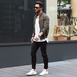 Dark Green Bomber Jacket Outfits For Men: This look with a dark green bomber jacket and black jeans isn't hard to pull off and is easy to change throughout the day. If you're hesitant about how to round off, complete this look with a pair of white low top sneakers.