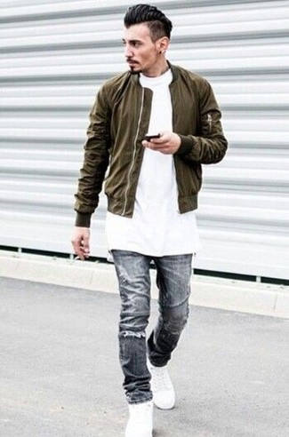 Charcoal Ripped Skinny Jeans Outfits For Men: An olive bomber jacket and charcoal ripped skinny jeans are both versatile menswear staples that will integrate really well within your daily off-duty rotation. Let your outfit coordination skills truly shine by completing your look with white leather high top sneakers.