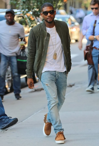 Usher wearing Olive Bomber Jacket, White Crew-neck T-shirt, Light Blue Ripped Jeans, Tan Suede Desert Boots