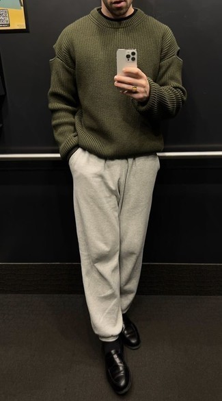 Grey Sweatpants Outfits For Men: Parade your prowess in menswear styling in this casual pairing of an olive crew-neck sweater and grey sweatpants. Add a pair of black leather loafers to this ensemble for an extra dose of sophistication.