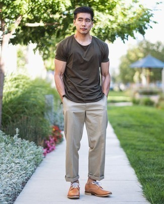 987+ Smart Casual Hot Weather Outfits For Men: This casual combo of an olive crew-neck t-shirt and beige chinos is extremely easy to pull together without a second thought, helping you look sharp and prepared for anything without spending a ton of time rummaging through your closet. And if you want to instantly up the style ante of this outfit with one single piece, add a pair of tan leather derby shoes to the mix.