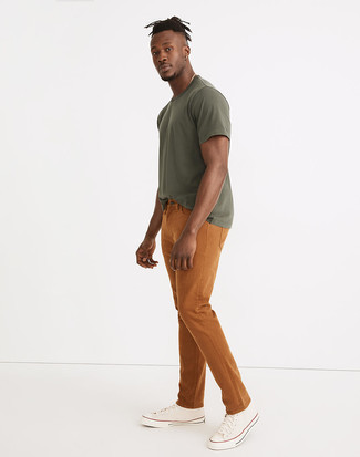 Beige Canvas High Top Sneakers Outfits For Men: Dress in an olive crew-neck t-shirt and tobacco jeans for a casual and stylish outfit. Our favorite of a variety of ways to finish off this look is a pair of beige canvas high top sneakers.