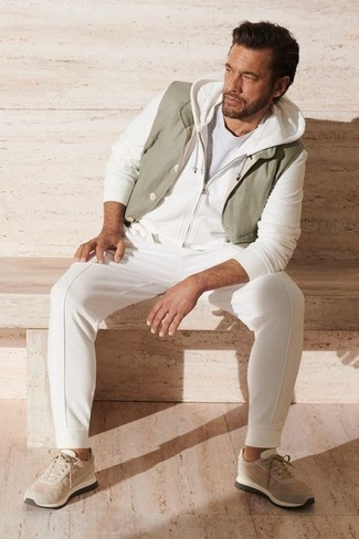 Olive Gilet Outfits For Men: This combo of an olive gilet and a white crew-neck t-shirt spells comfort and masculine style. When this getup is just too much, dress it down by wearing beige athletic shoes.