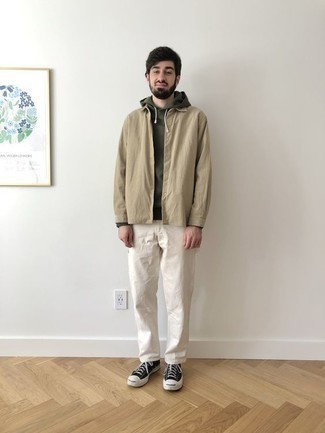 Black and White Canvas Low Top Sneakers Outfits For Men: You'll be surprised at how super easy it is for any man to put together this casual outfit. Just an olive hoodie and white chinos. Complete this getup with black and white canvas low top sneakers and the whole look will come together.